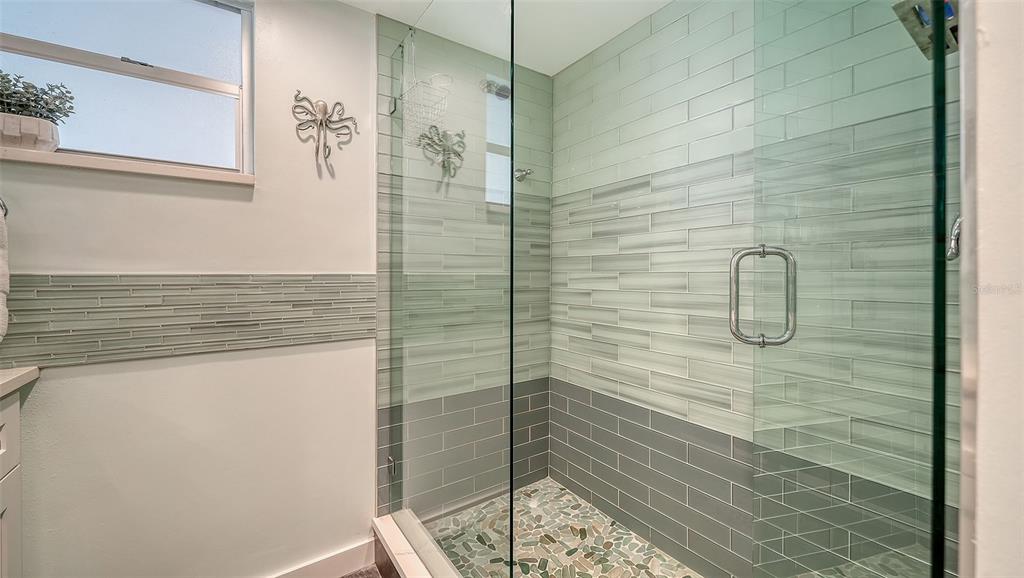 4440 Exeter Drive, Unit 301 Longboat Key, FL 34228 - Photo 16 of 72 a bathroom with a shower