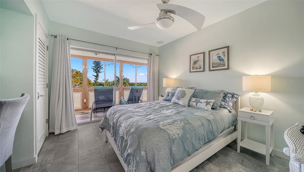 4440 Exeter Drive, Unit 301 Longboat Key, FL 34228 - Photo 17 of 72 a bedroom with a bed and a large window