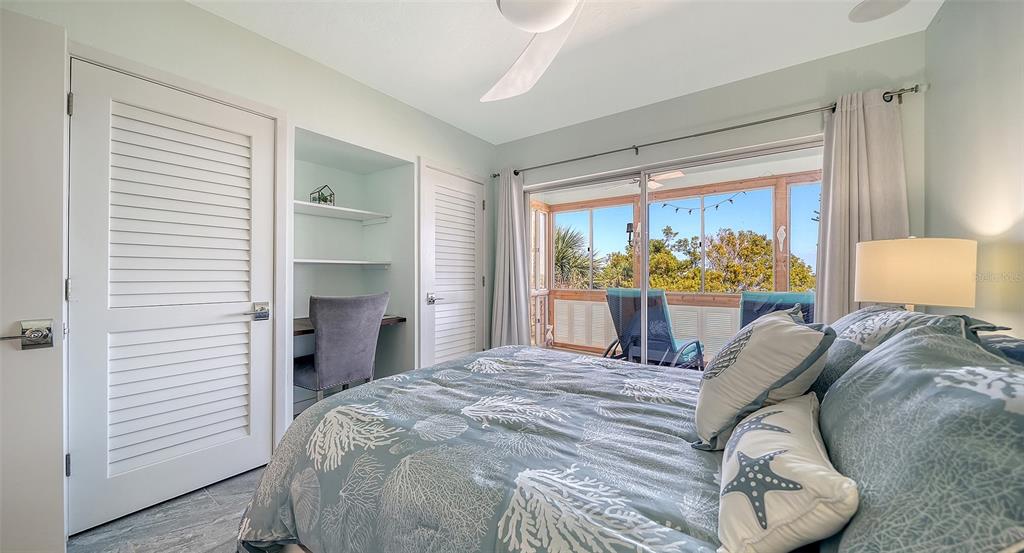 4440 Exeter Drive, Unit 301 Longboat Key, FL 34228 - Photo 18 of 72 a bedroom with a bed and a large window