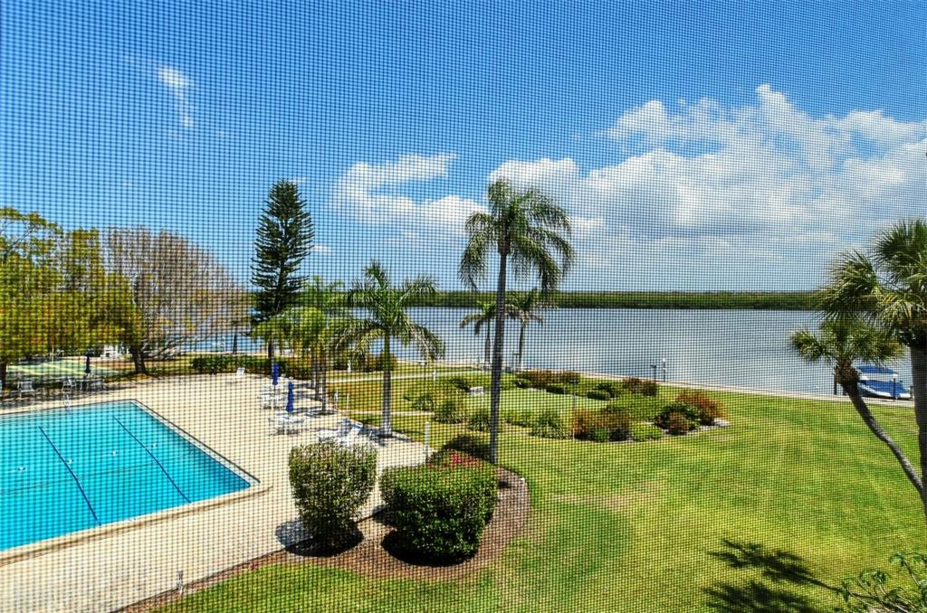 4440 Exeter Drive, Unit 301 Longboat Key, FL 34228 - Photo 29 of 72 a view of a swimming pool with a yard