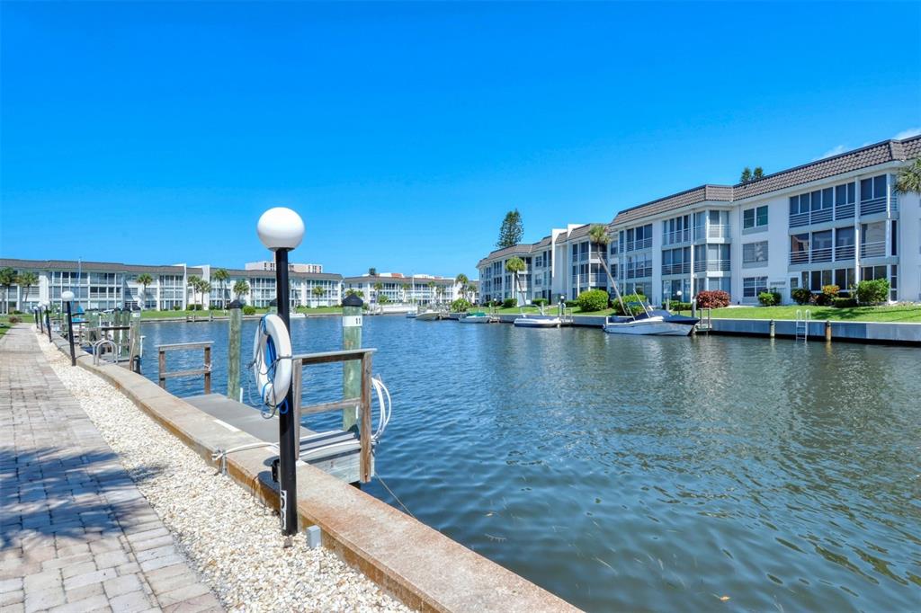 4440 Exeter Drive, Unit 301 Longboat Key, FL 34228 - Photo 57 of 72 a view of a lake with a house