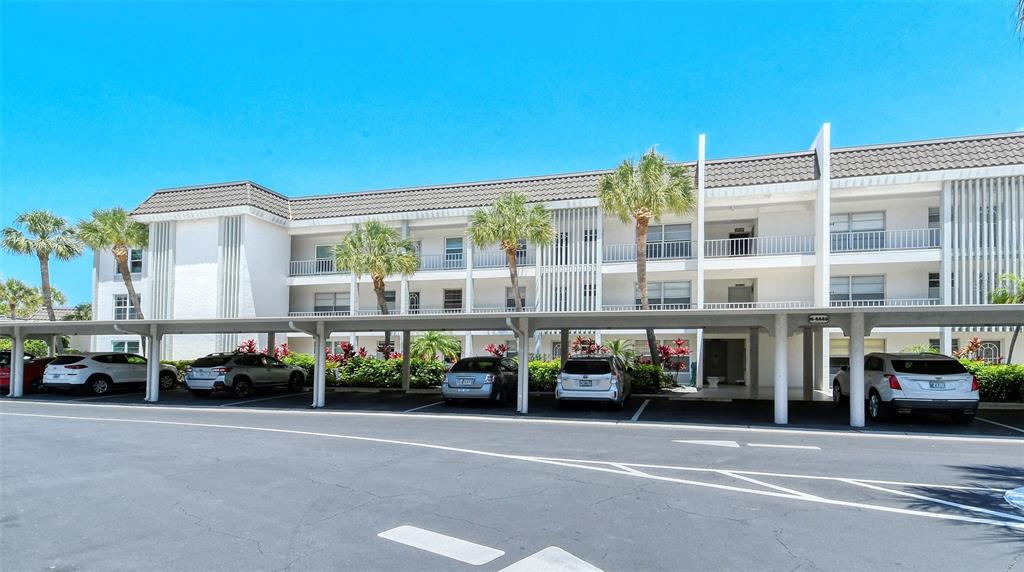 4440 Exeter Drive, Unit 301 Longboat Key, FL 34228 - Photo 70 of 72 a cars parked in front of a building