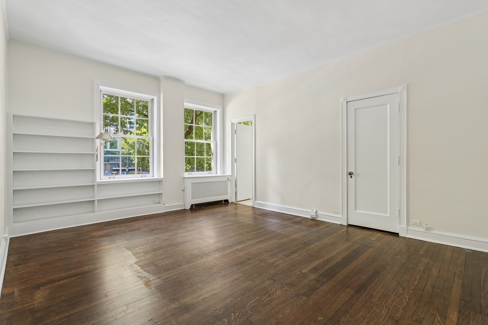 200 East Pearson Street, Unit 2E Chicago, IL 60611 - Photo 18 of 25 an empty room with wooden floor and windows