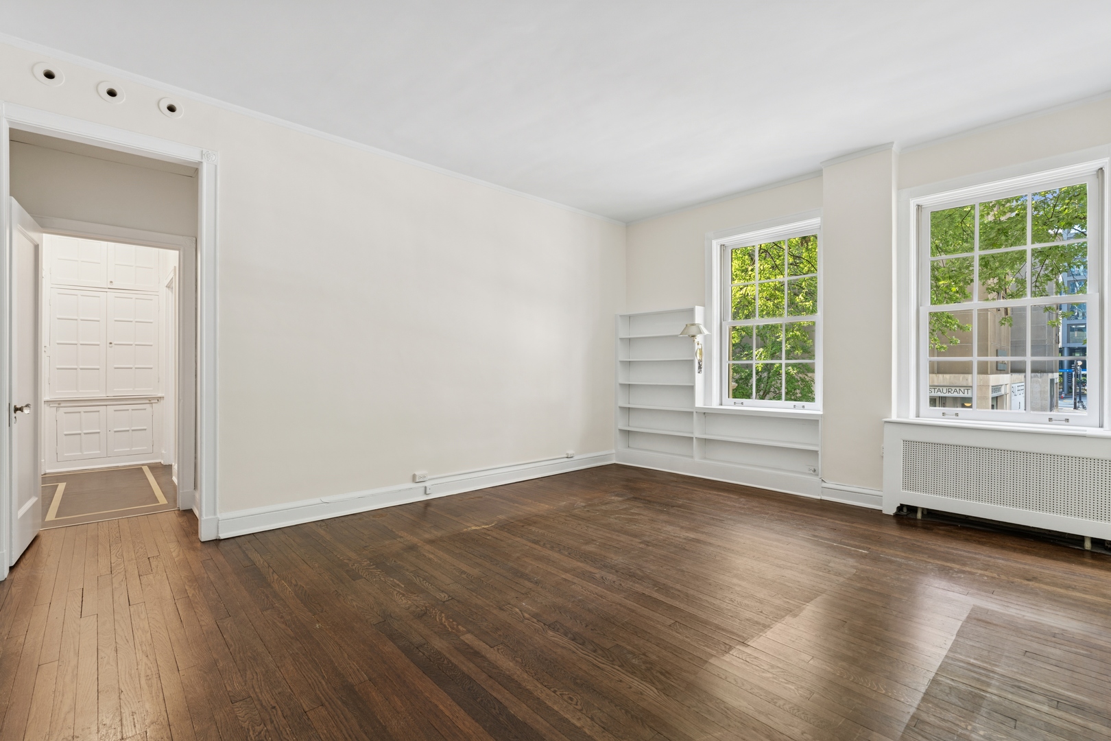 200 East Pearson Street, Unit 2E Chicago, IL 60611 - Photo 19 of 25 an empty room with wooden floor and windows
