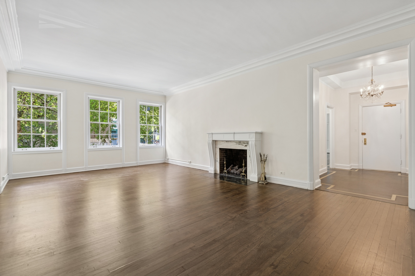 200 East Pearson Street, Unit 2E Chicago, IL 60611 - Photo 4 of 25 an empty room with wooden floor fireplace and windows