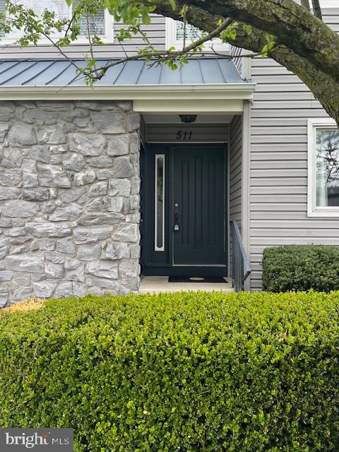 a view of front door of house with a yard