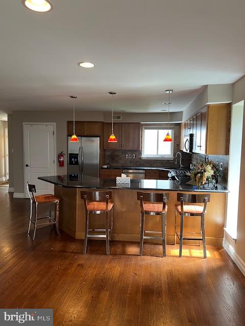 511 Chanticleer Cherry Hill, NJ 08003 - Photo 18 of 32 a living room with furniture a flat screen tv and kitchen view