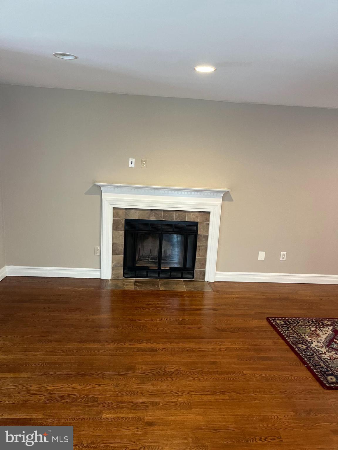 511 Chanticleer Cherry Hill, NJ 08003 - Photo 21 of 32 a view of an empty room with wooden floor and a fireplace