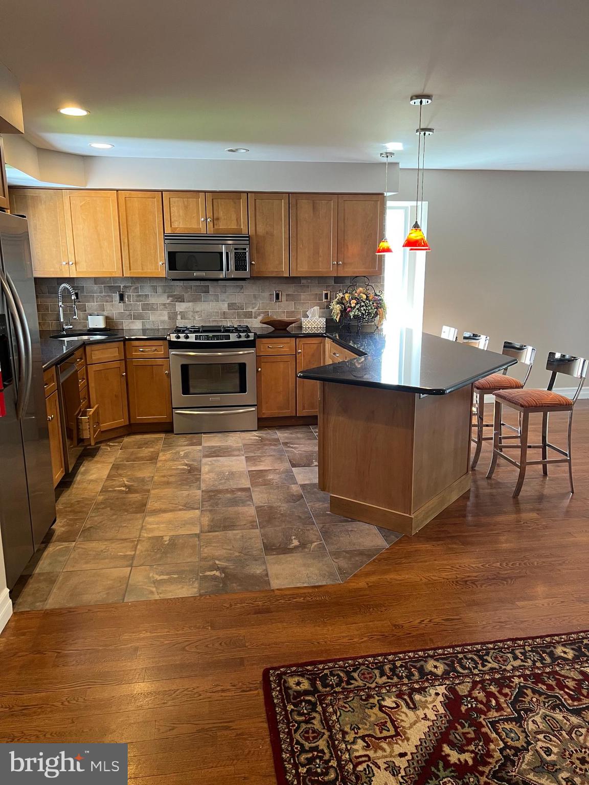 511 Chanticleer Cherry Hill, NJ 08003 - Photo 24 of 32 a kitchen with stainless steel appliances granite countertop a stove a sink and a microwave