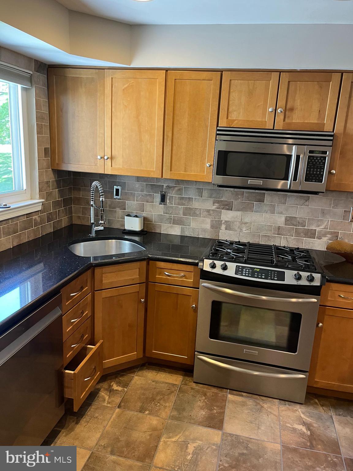 511 Chanticleer Cherry Hill, NJ 08003 - Photo 32 of 32 a kitchen with granite countertop a stove a sink and a microwave