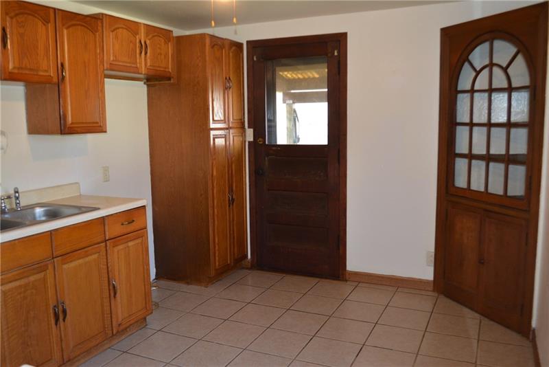 305 Clever Avenue McKees Rocks, PA 15136 - Photo 2 of 10 Kitchen has oak cabinetry, ceramic flooring with built in china cabinet!