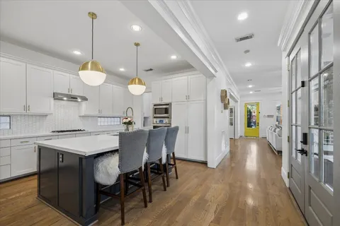 a kitchen with sink stove and cabinets