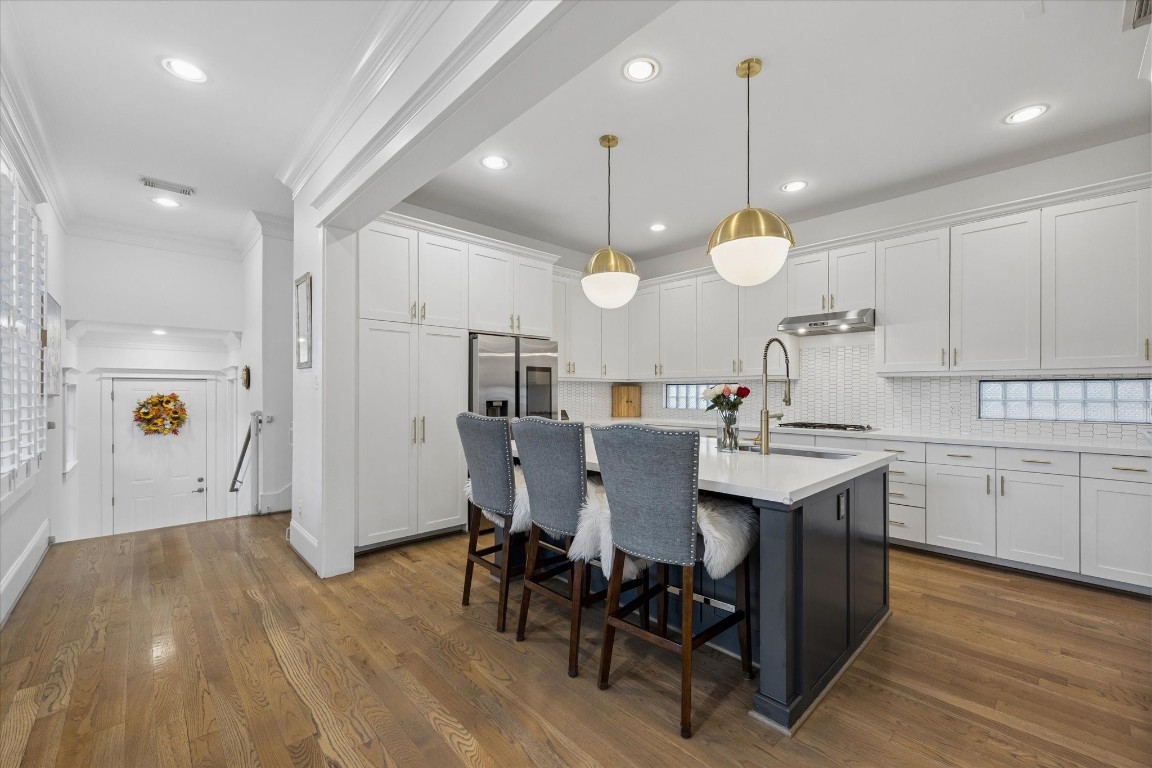 3535 Michaux Street Houston, TX 77009 - Photo 16 of 48 White, clean and bright, the kitchen offers quartz countertops, all stainless steel appliances including a refrigerator with programmable digital photo displays.