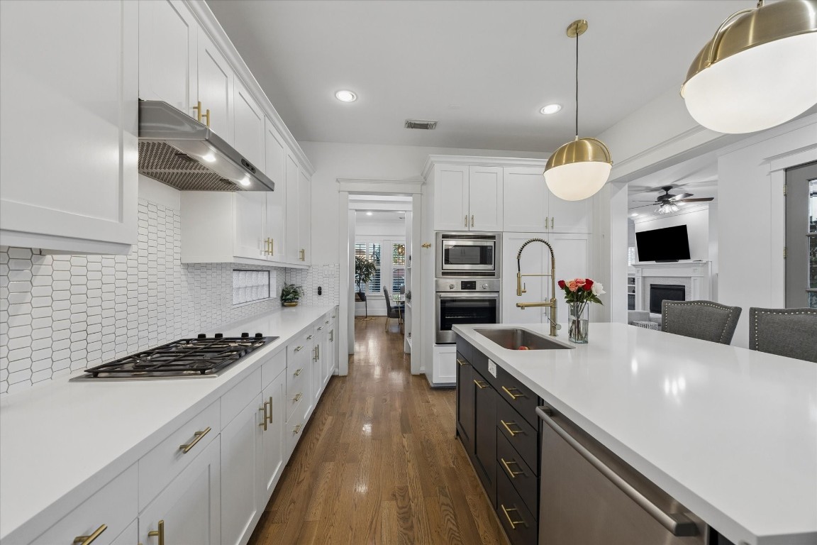 3535 Michaux Street Houston, TX 77009 - Photo 17 of 48 You'll love the large, quartz island, the gas range, the beautiful pendant lighting, a stylish backsplash and a brand new oven.