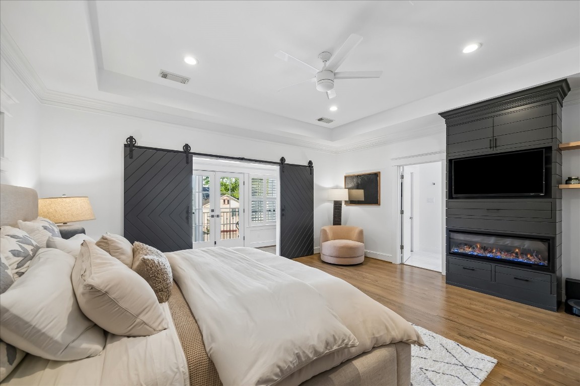 3535 Michaux Street Houston, TX 77009 - Photo 24 of 48 The electric fireplace adds a little warmth and drama to the primary bedroom in cooler months.