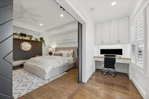 a bedroom with a bed and a chandelier