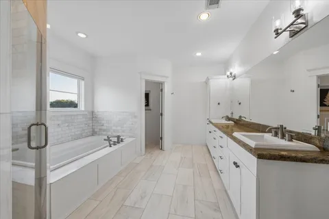 a bathroom with a double vanity sink toilet mirror and shower