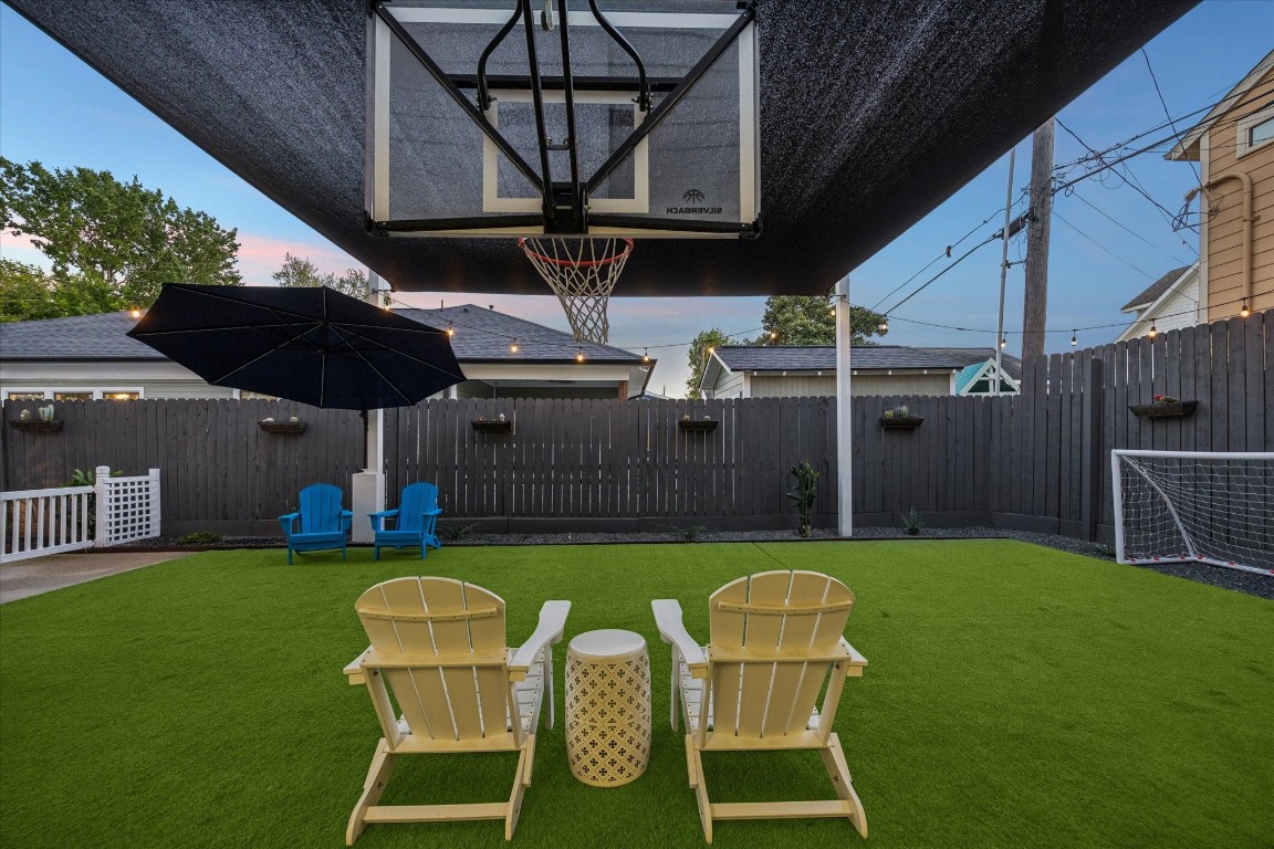 3535 Michaux Street Houston, TX 77009 - Photo 43 of 48 This backyard features a versatile recreational space with artificial turf, a basketball hoop, and room for small soccer goals as shown.