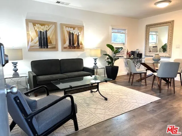 a living room with furniture rug and a window