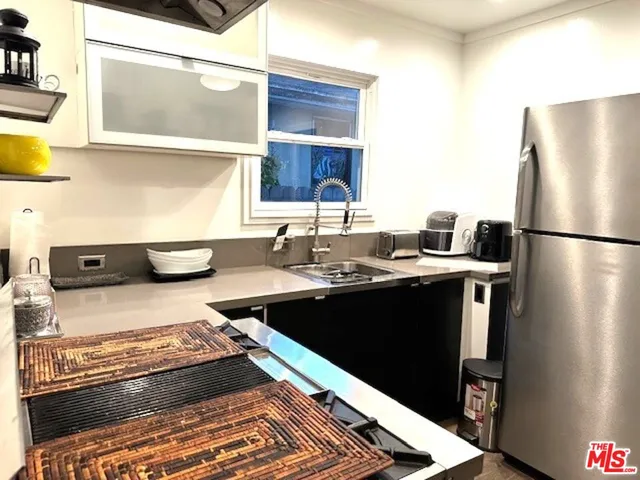 a kitchen with a refrigerator and a sink