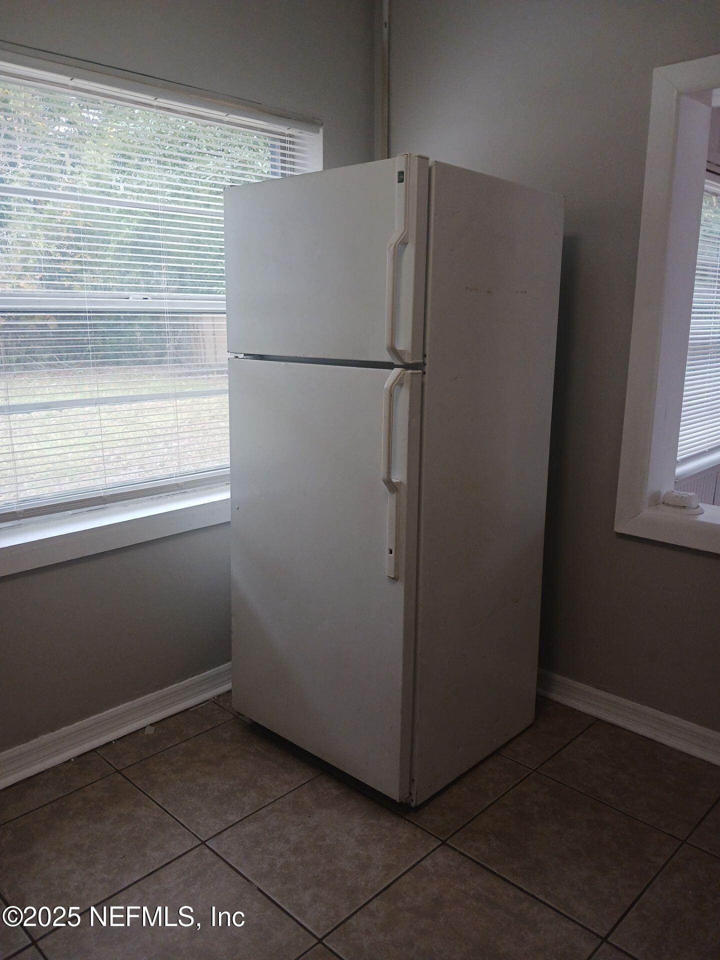 1669 Stafford Road Jacksonville, FL 32208 - Photo 6 of 17 a view of a refrigerator in kitchen and an empty room
