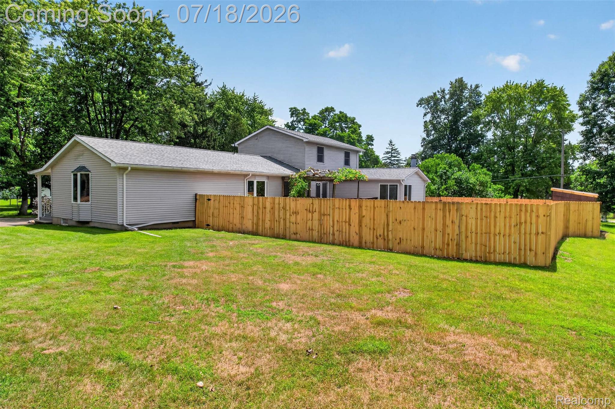 1437 East Cook Road Grand Blanc, MI 48439 - Photo 8 of 69 Spacious backyard featuring a new wooden privacy fence, a detached storage shed, and mature perimeter trees