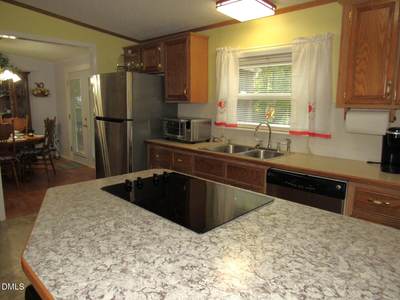 34 Waters Edge Cove Henderson, NC 27537 - Photo 14 of 44 a kitchen with stainless steel appliances granite countertop a sink stove and refrigerator