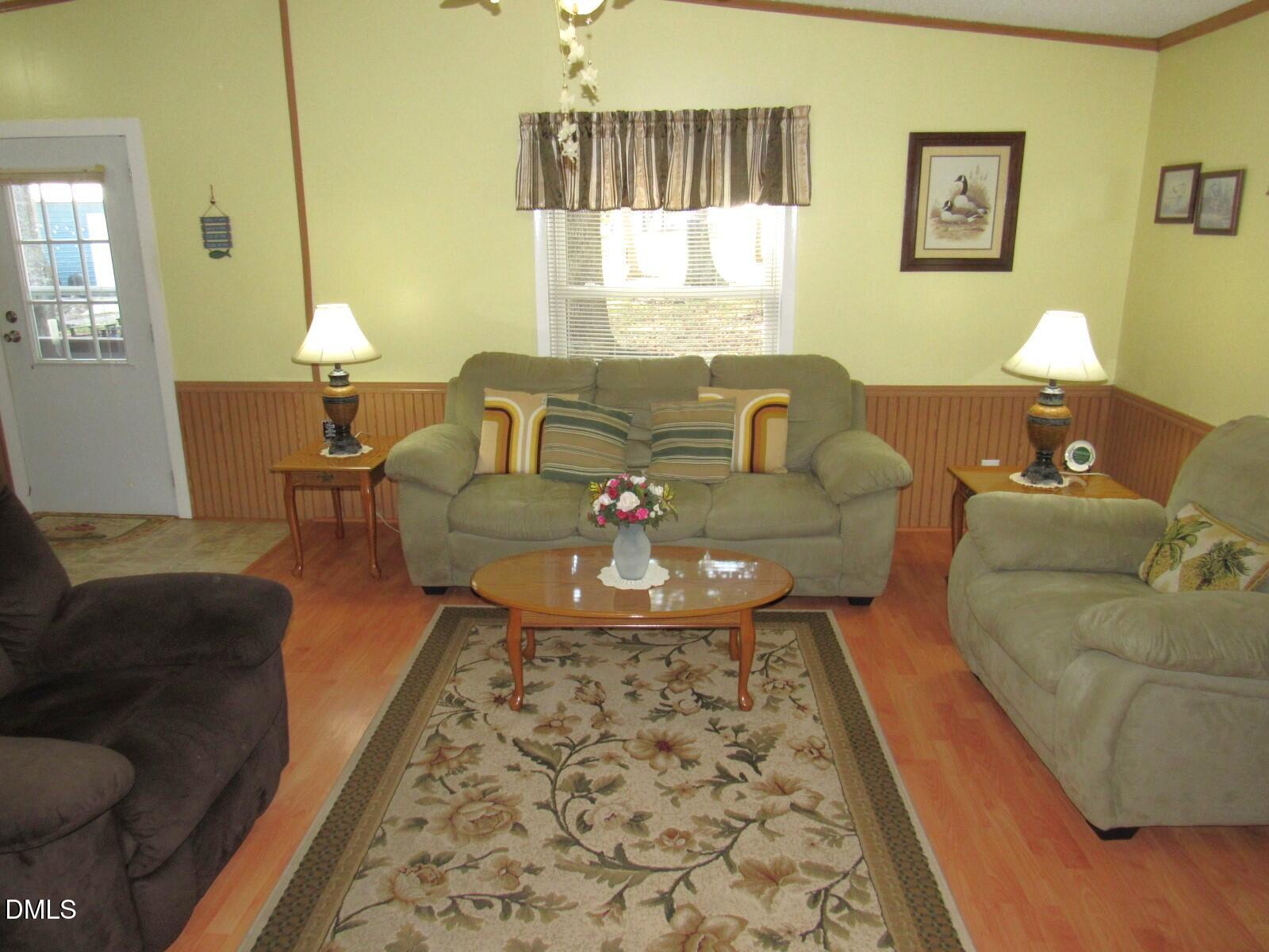 34 Waters Edge Cove Henderson, NC 27537 - Photo 17 of 44 a living room with furniture and a large window