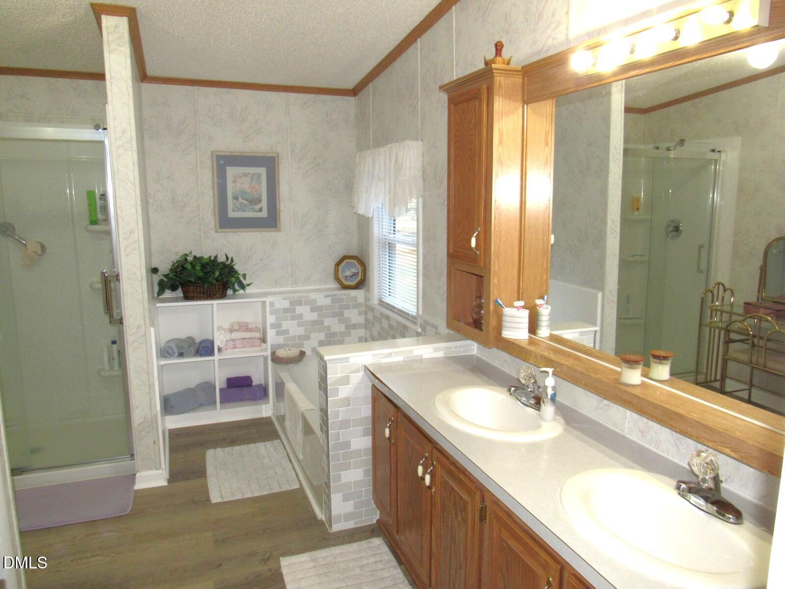 34 Waters Edge Cove Henderson, NC 27537 - Photo 21 of 44 a bathroom with a granite countertop sink and a mirror