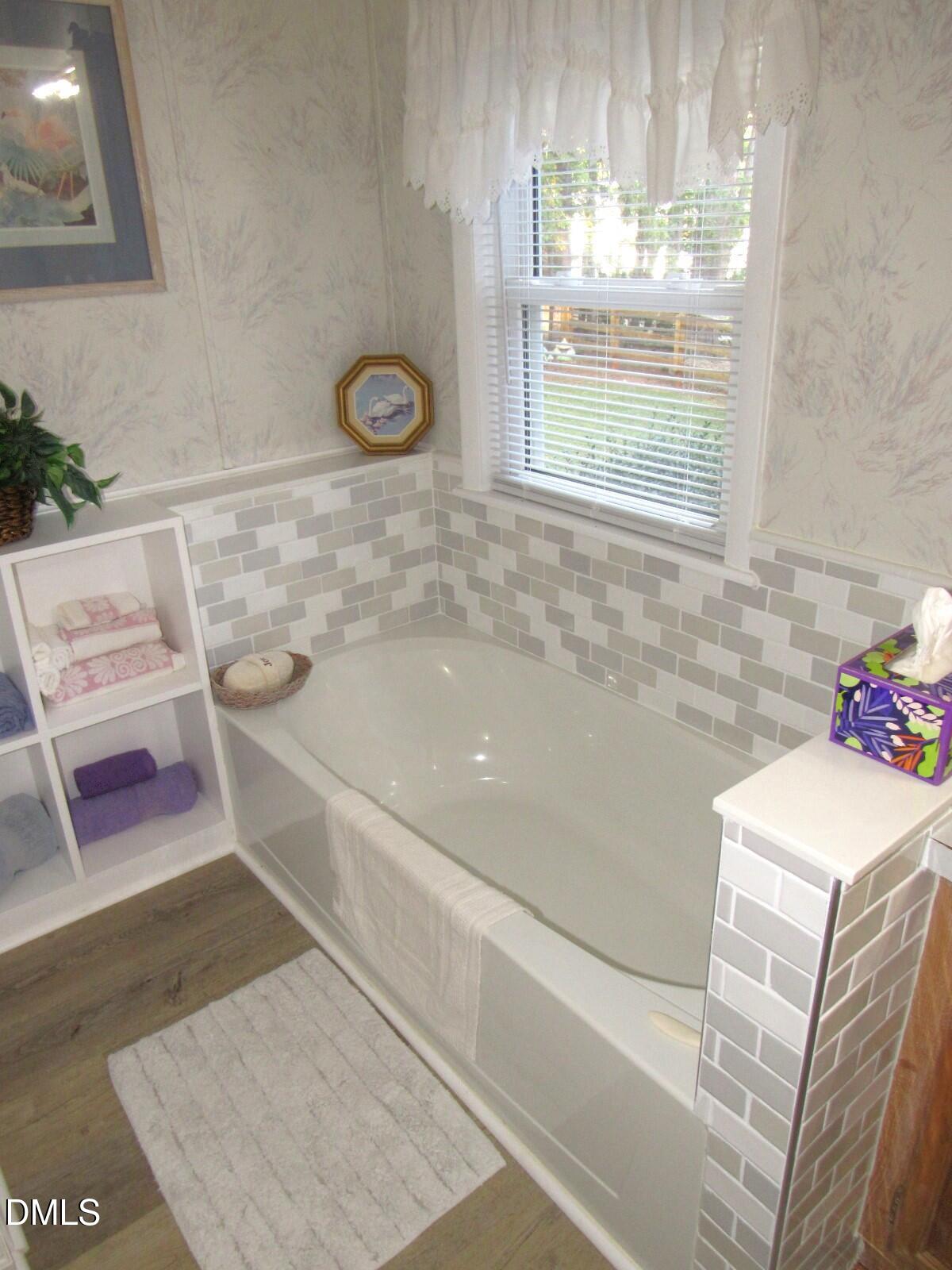 34 Waters Edge Cove Henderson, NC 27537 - Photo 22 of 44 a bathroom with a sink a bathtub and window