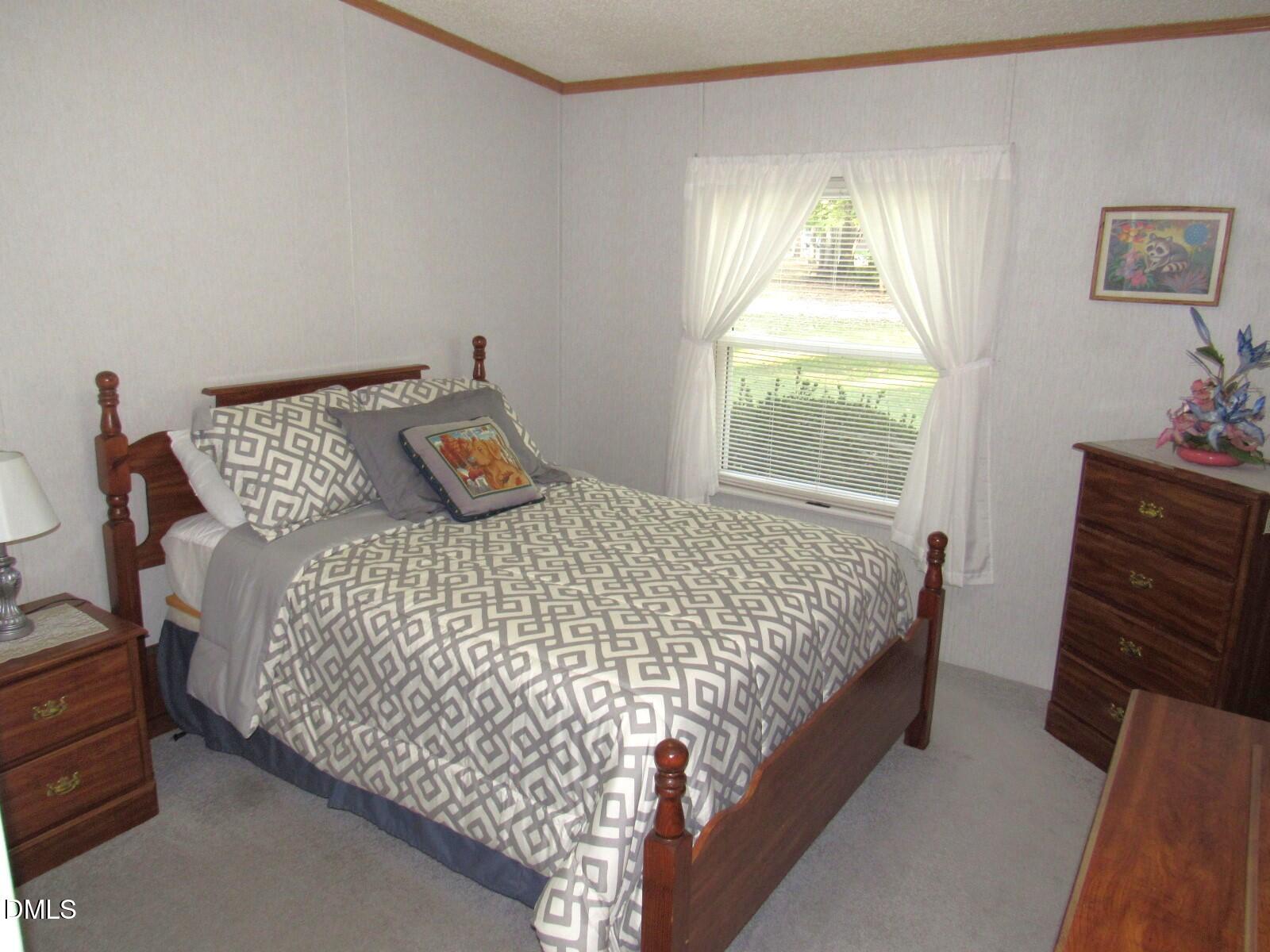 34 Waters Edge Cove Henderson, NC 27537 - Photo 24 of 44 a bedroom with a bed and a window