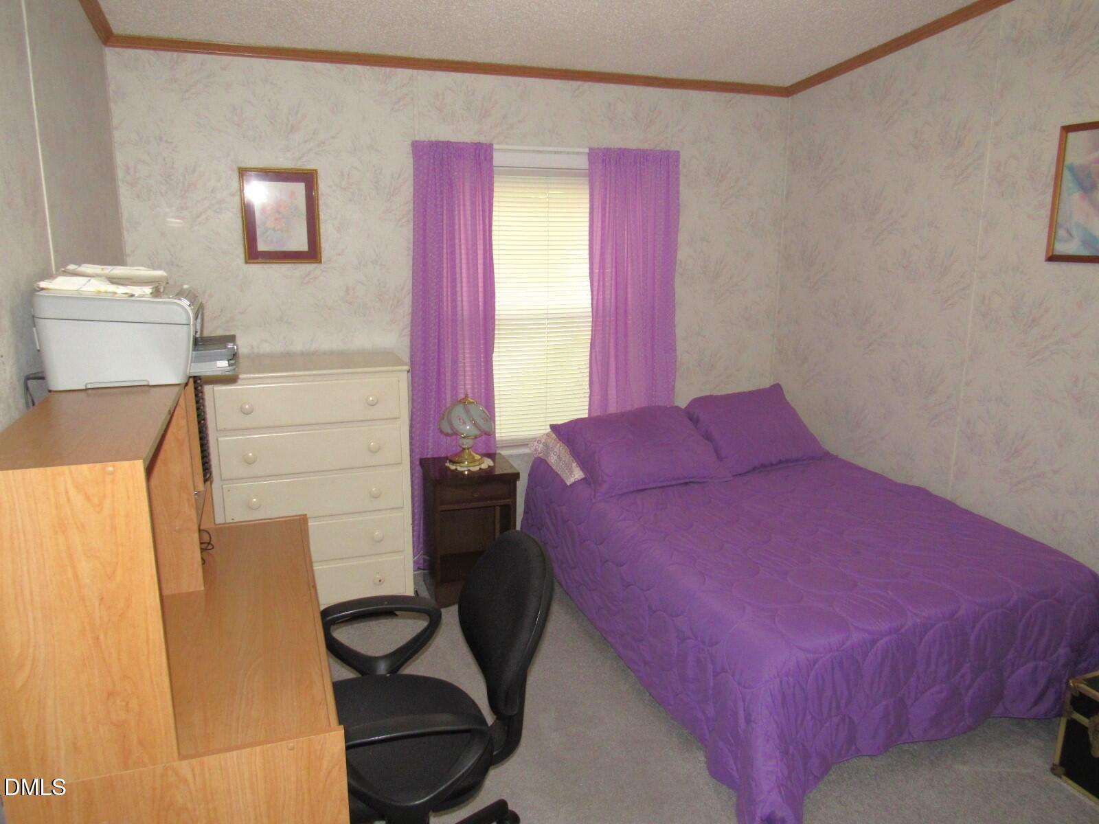 34 Waters Edge Cove Henderson, NC 27537 - Photo 25 of 44 a bedroom with a bed and a dresser next to a window