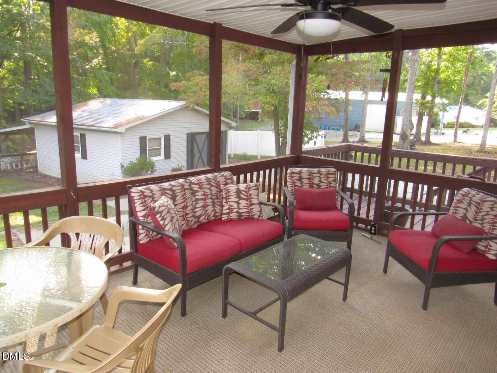 34 Waters Edge Cove Henderson, NC 27537 - Photo 28 of 44 a roof deck with a table and chairs