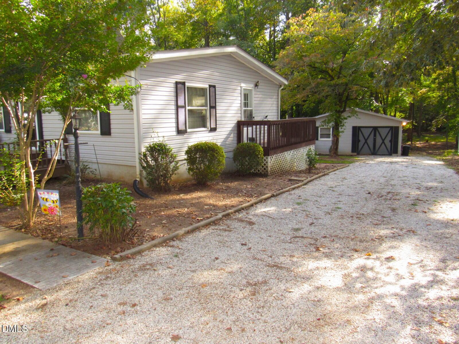 34 Waters Edge Cove Henderson, NC 27537 - Photo 4 of 44 a front view of a house with garden