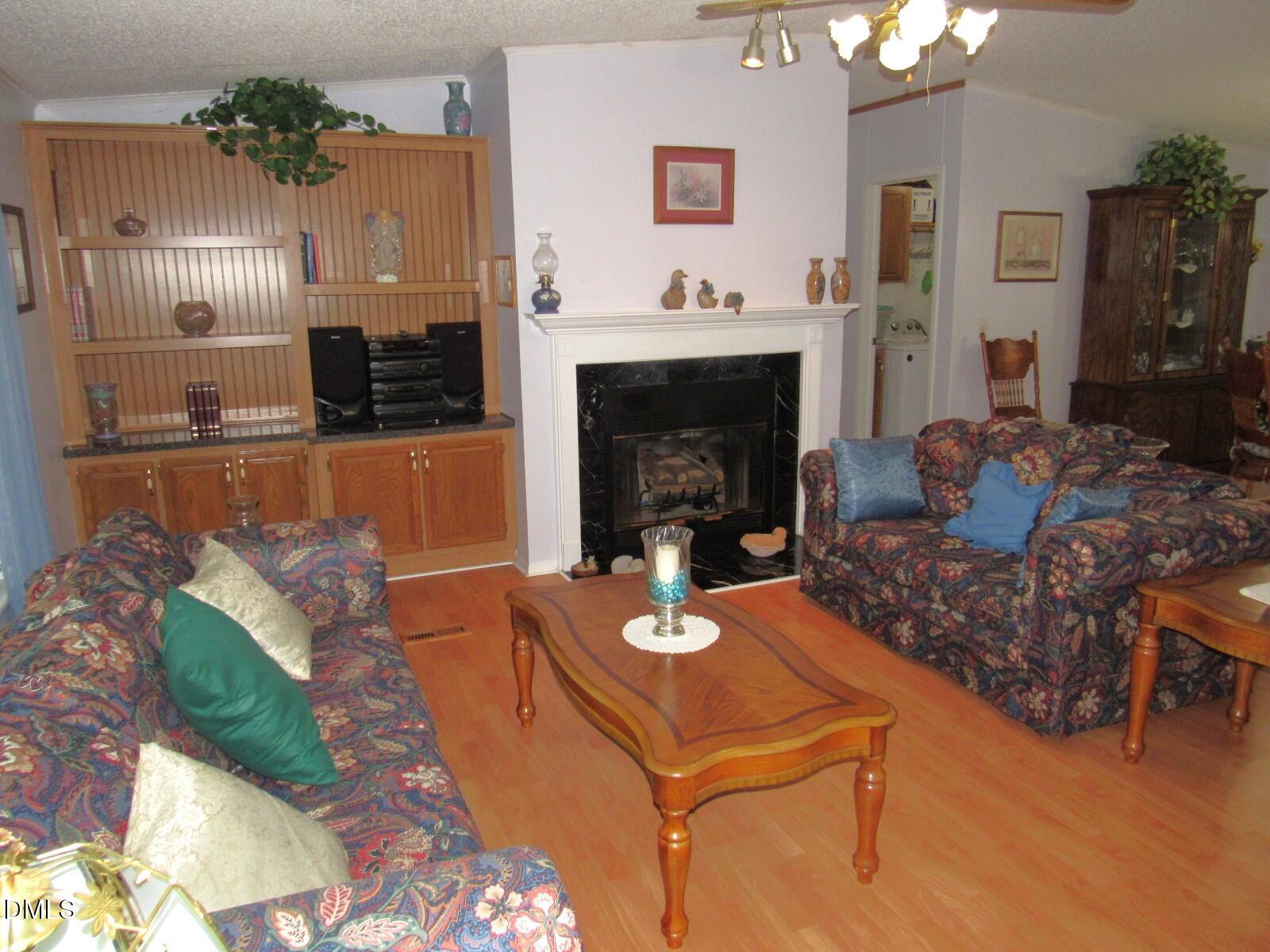 34 Waters Edge Cove Henderson, NC 27537 - Photo 7 of 44 a living room with furniture and a fireplace