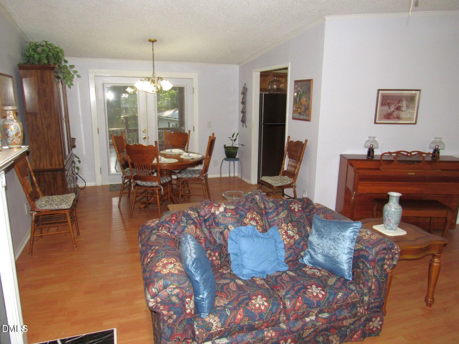 34 Waters Edge Cove Henderson, NC 27537 - Photo 8 of 44 a living room with furniture and a chandelier