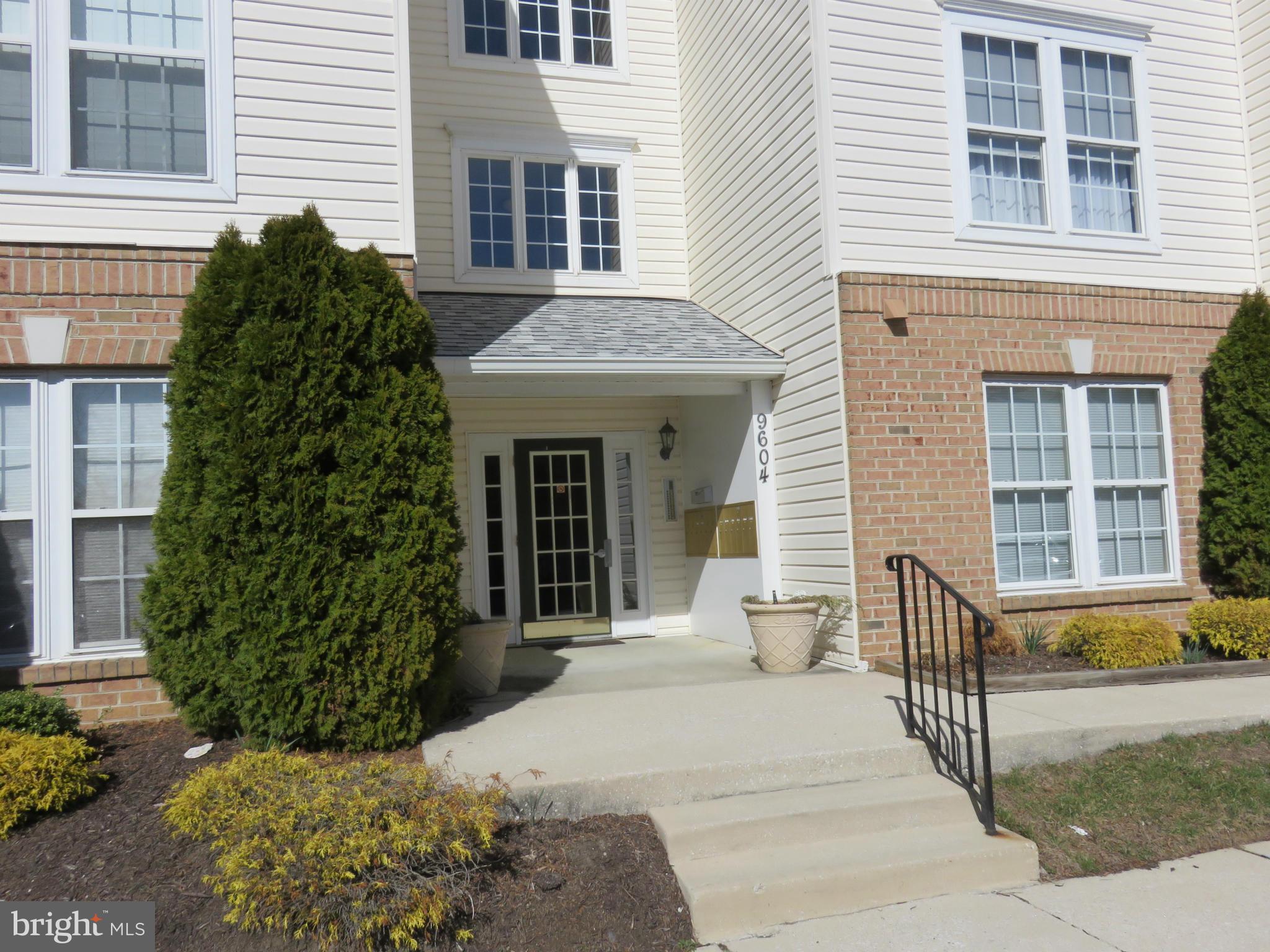 9604 Haven Farm Road, Unit K Perry Hall, MD 21128 - Photo 21 of 24 a view of a house with a small yard and potted plants