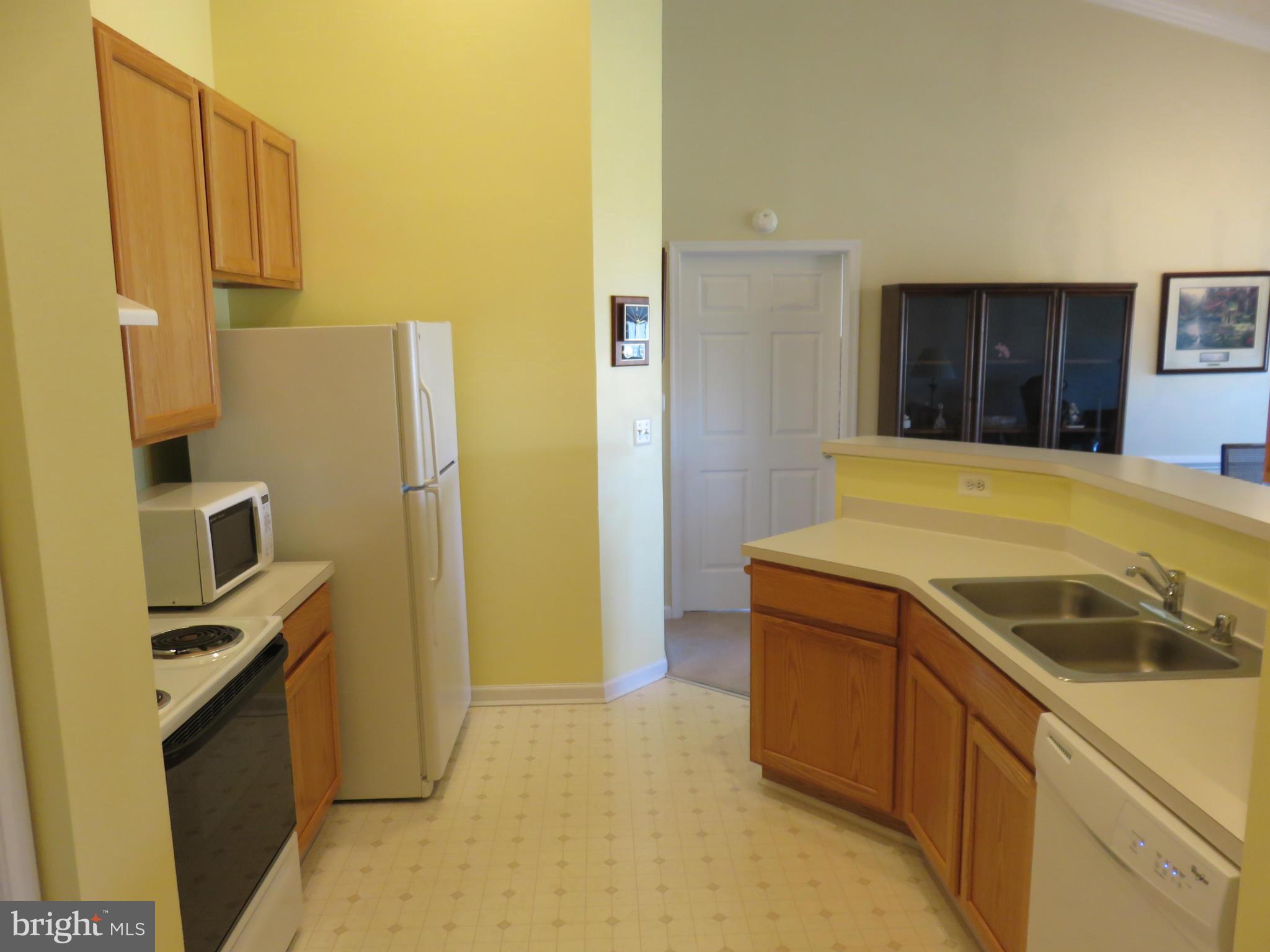 9604 Haven Farm Road, Unit K Perry Hall, MD 21128 - Photo 4 of 24 a kitchen that has a sink and a refrigerator