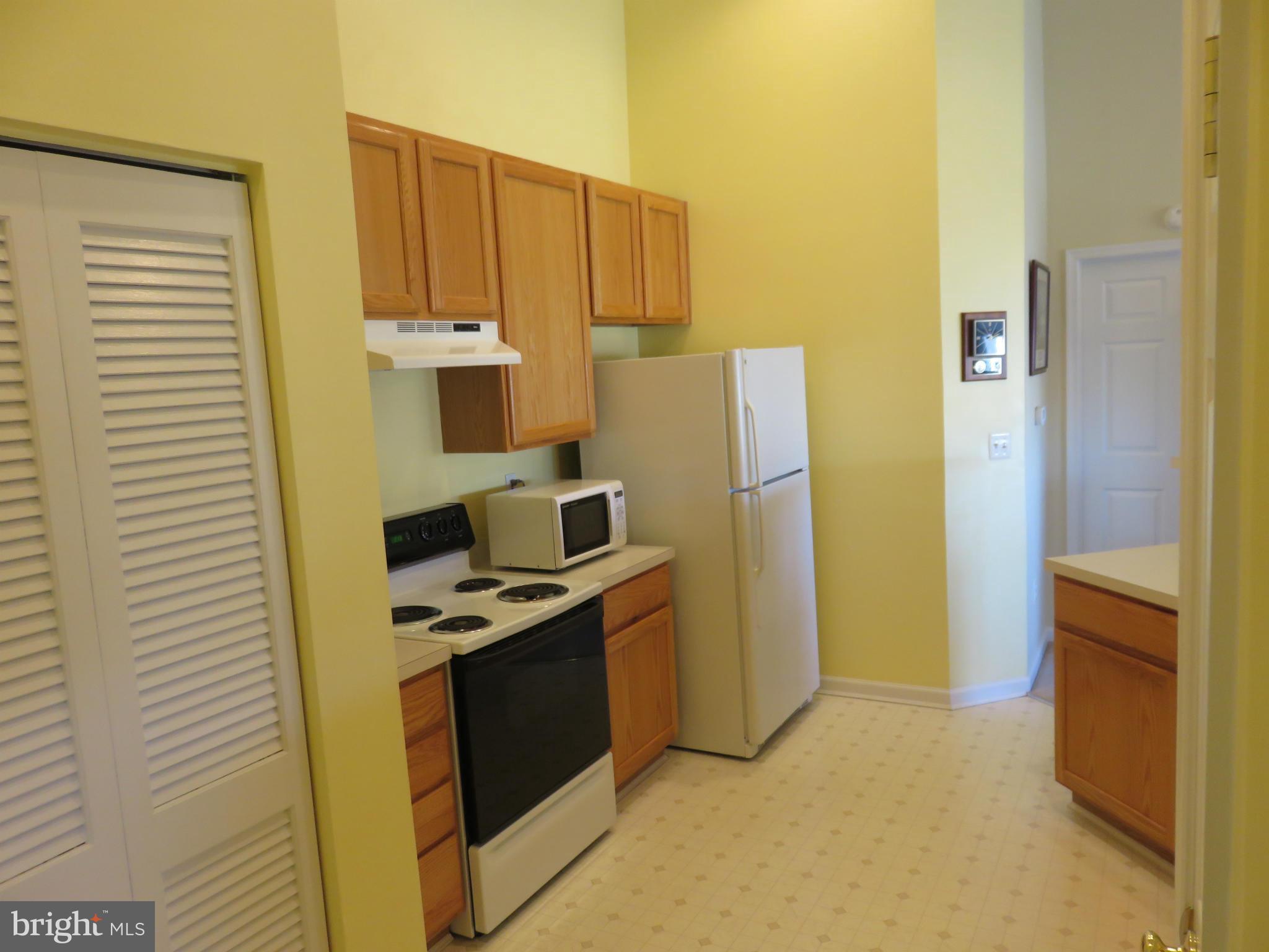 9604 Haven Farm Road, Unit K Perry Hall, MD 21128 - Photo 5 of 24 a kitchen with a refrigerator stove and a sink