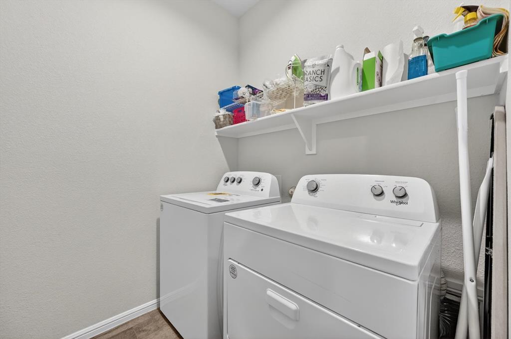 9604 Cherryville Road Fort Worth, TX 76108 - Photo 31 of 40 Dedicated laundry area featuring white walls, wood-finish flooring, and a built-in white shelving unit