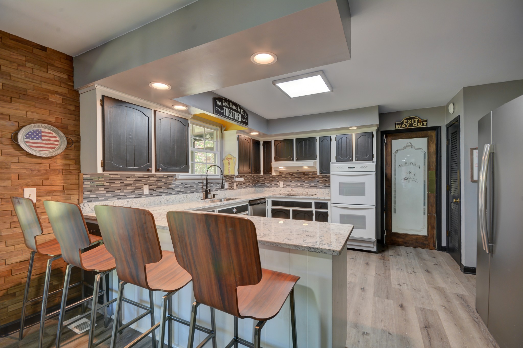 463 Walton Ferry Road Hendersonville, TN 37075 - Photo 12 of 37 a kitchen with stainless steel appliances granite countertop a stove top oven a sink dishwasher a dining table and chairs with wooden floor