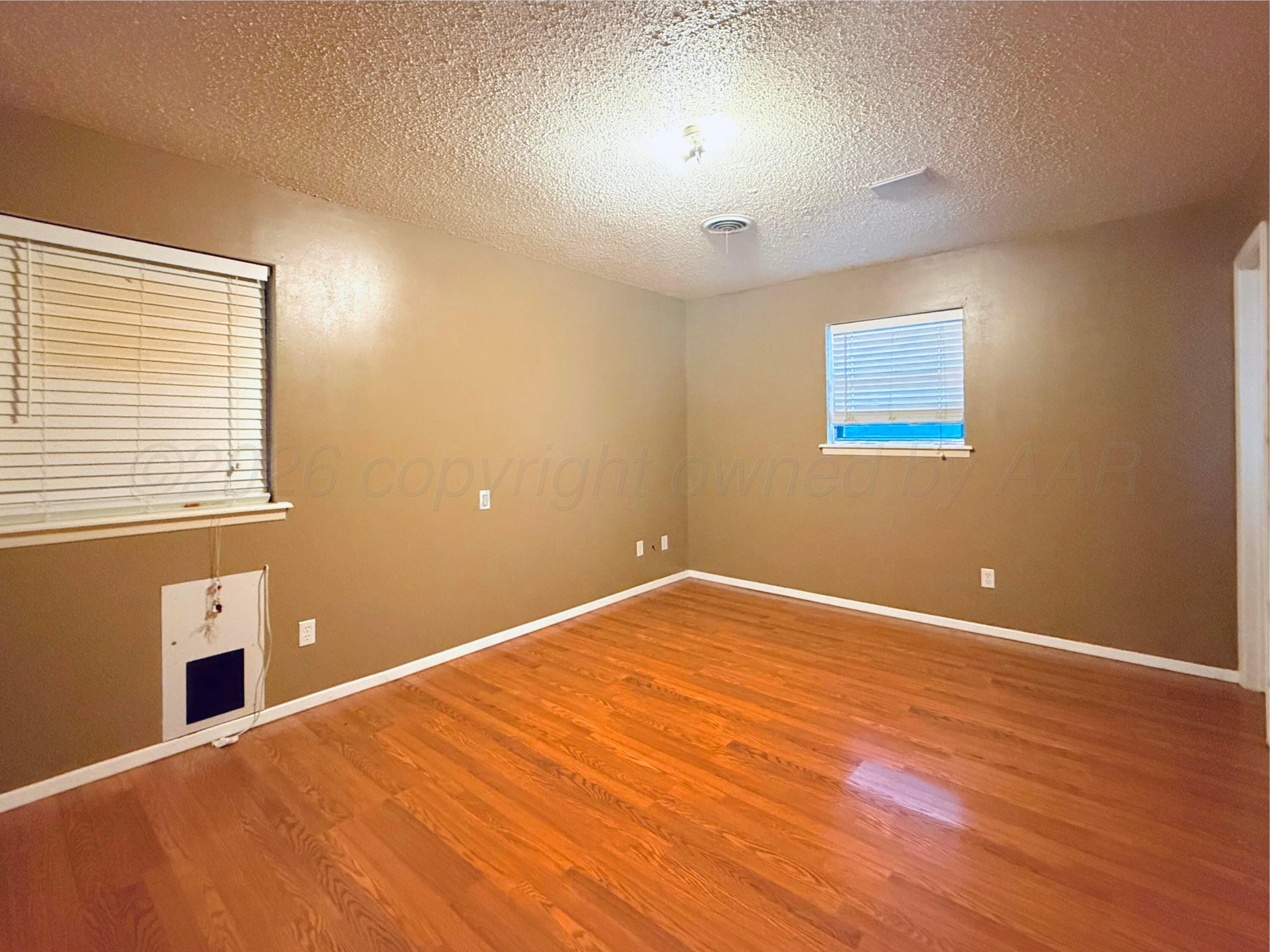 1713 Sunset Avenue Dumas, TX 79029 - Photo 12 of 15 a view of an empty room with a window