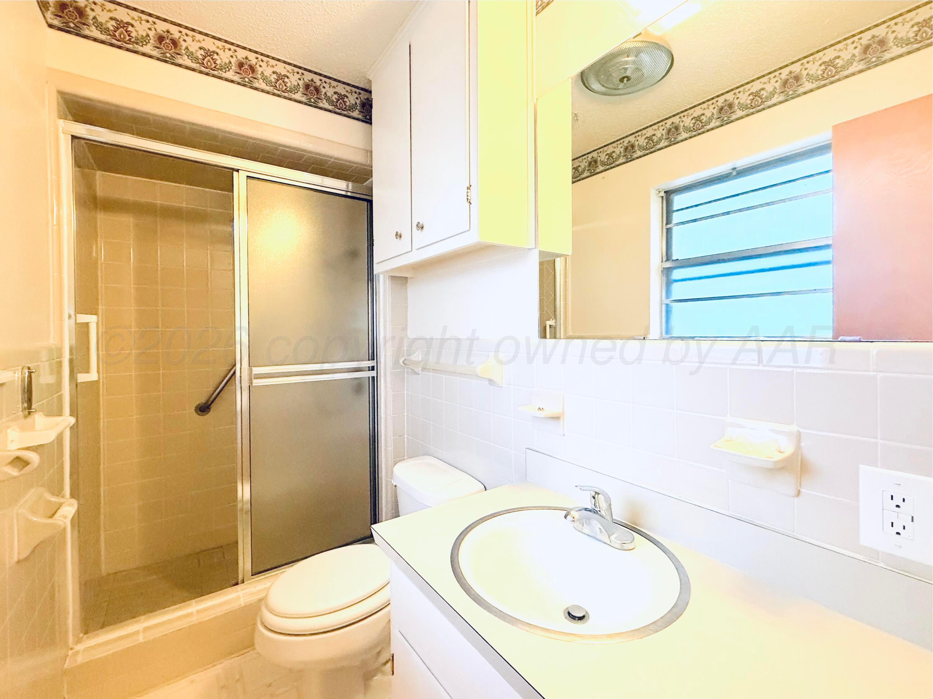 1713 Sunset Avenue Dumas, TX 79029 - Photo 13 of 15 a bathroom with a sink toilet and shower