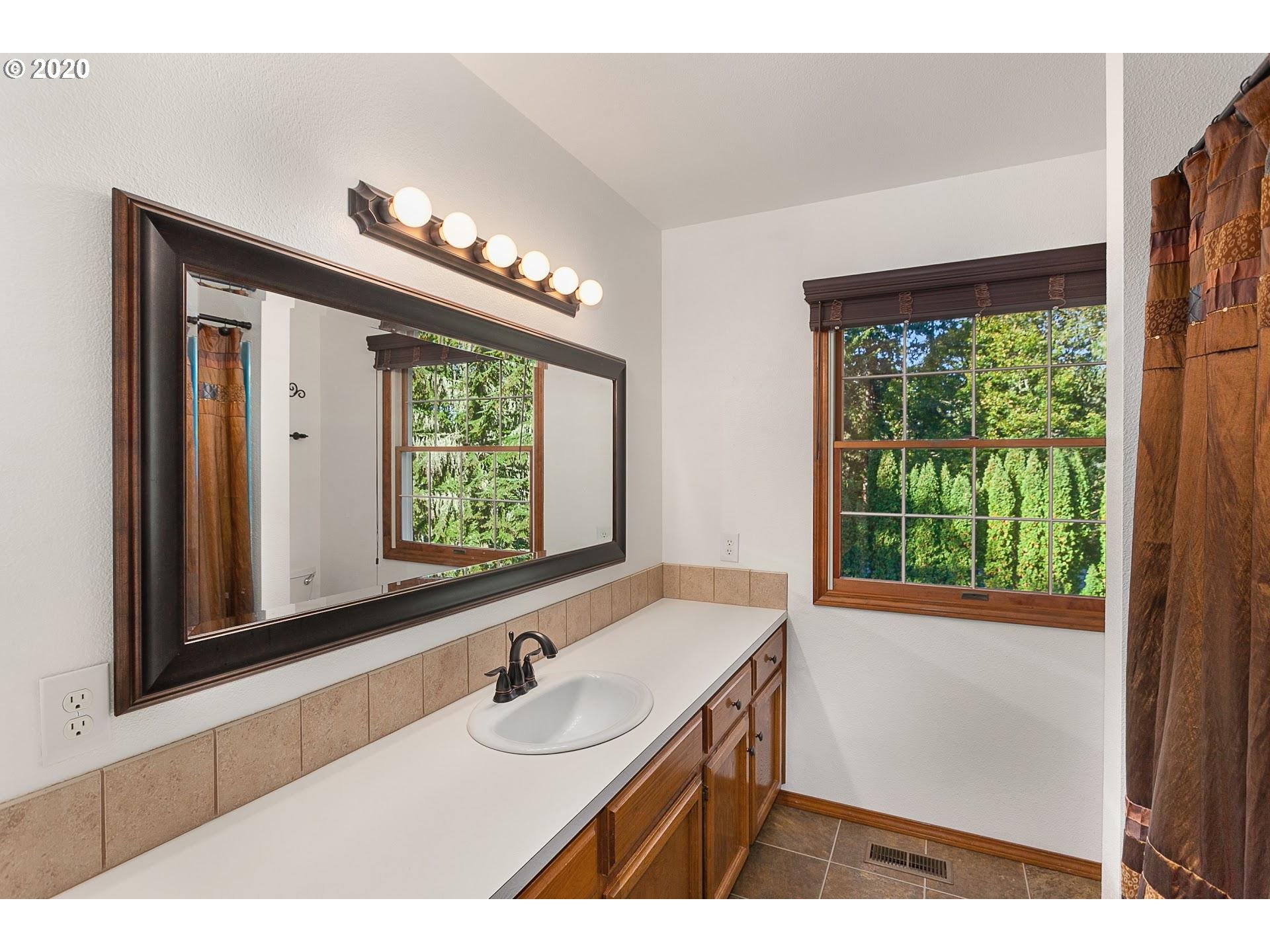 18740 Southwest Seiffert Road Sherwood, OR 97140 - Photo 15 of 32 a bathroom with a sink and a large mirror