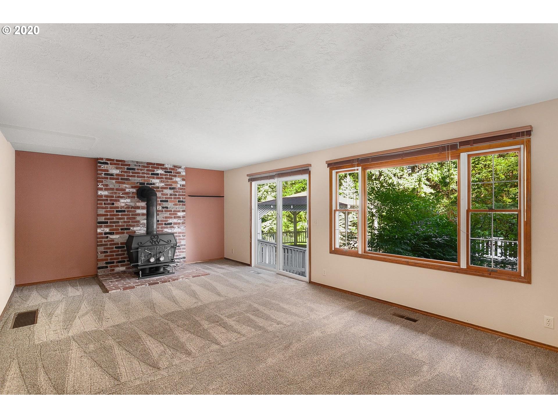 18740 Southwest Seiffert Road Sherwood, OR 97140 - Photo 16 of 32 a view of an empty room with a fireplace and a large window