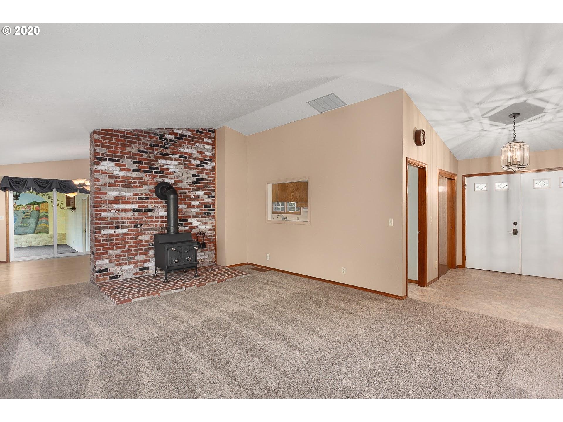18740 Southwest Seiffert Road Sherwood, OR 97140 - Photo 4 of 32 a view of an empty room with a fireplace