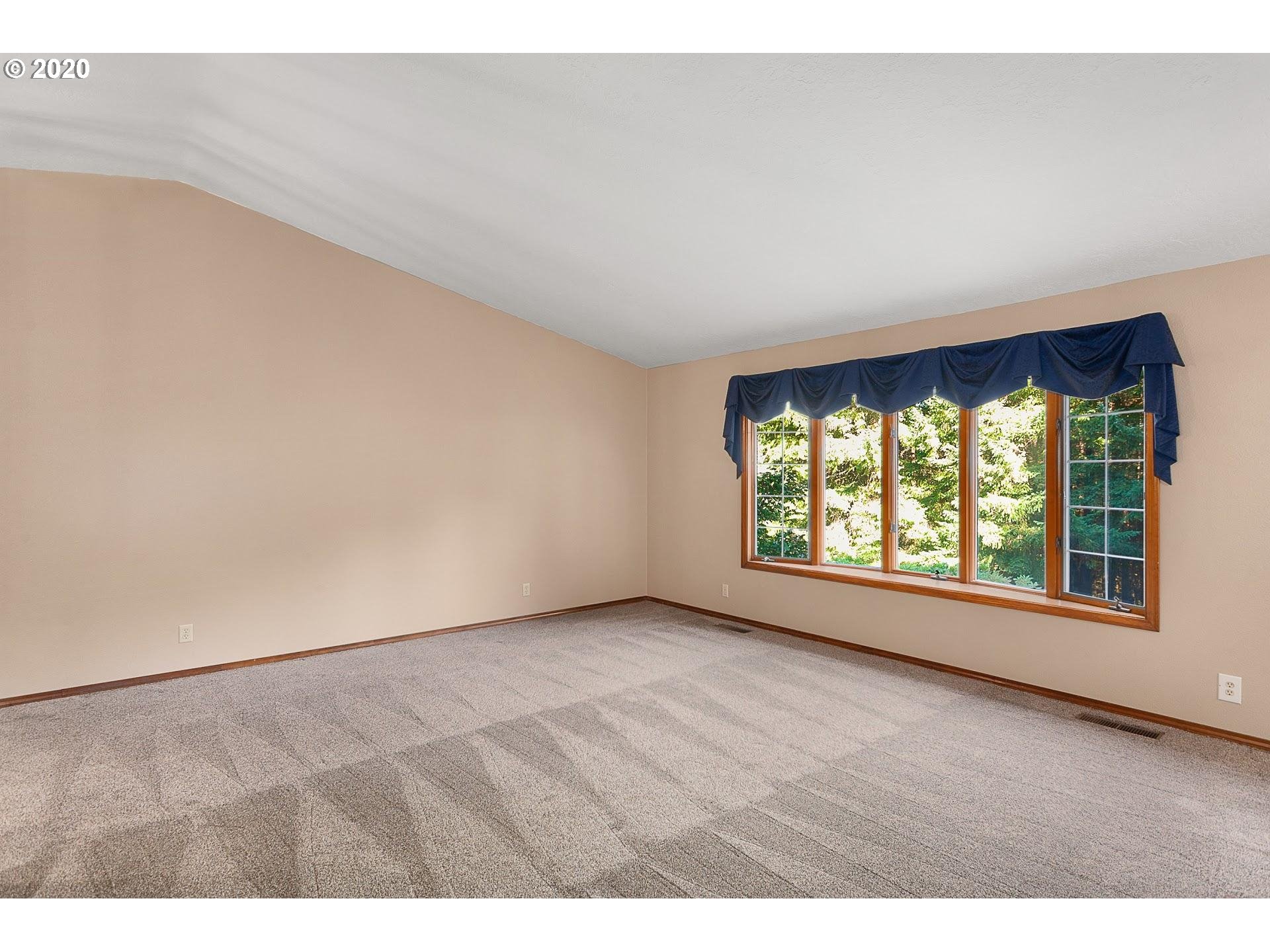 18740 Southwest Seiffert Road Sherwood, OR 97140 - Photo 6 of 32 an empty room with wooden floor and windows