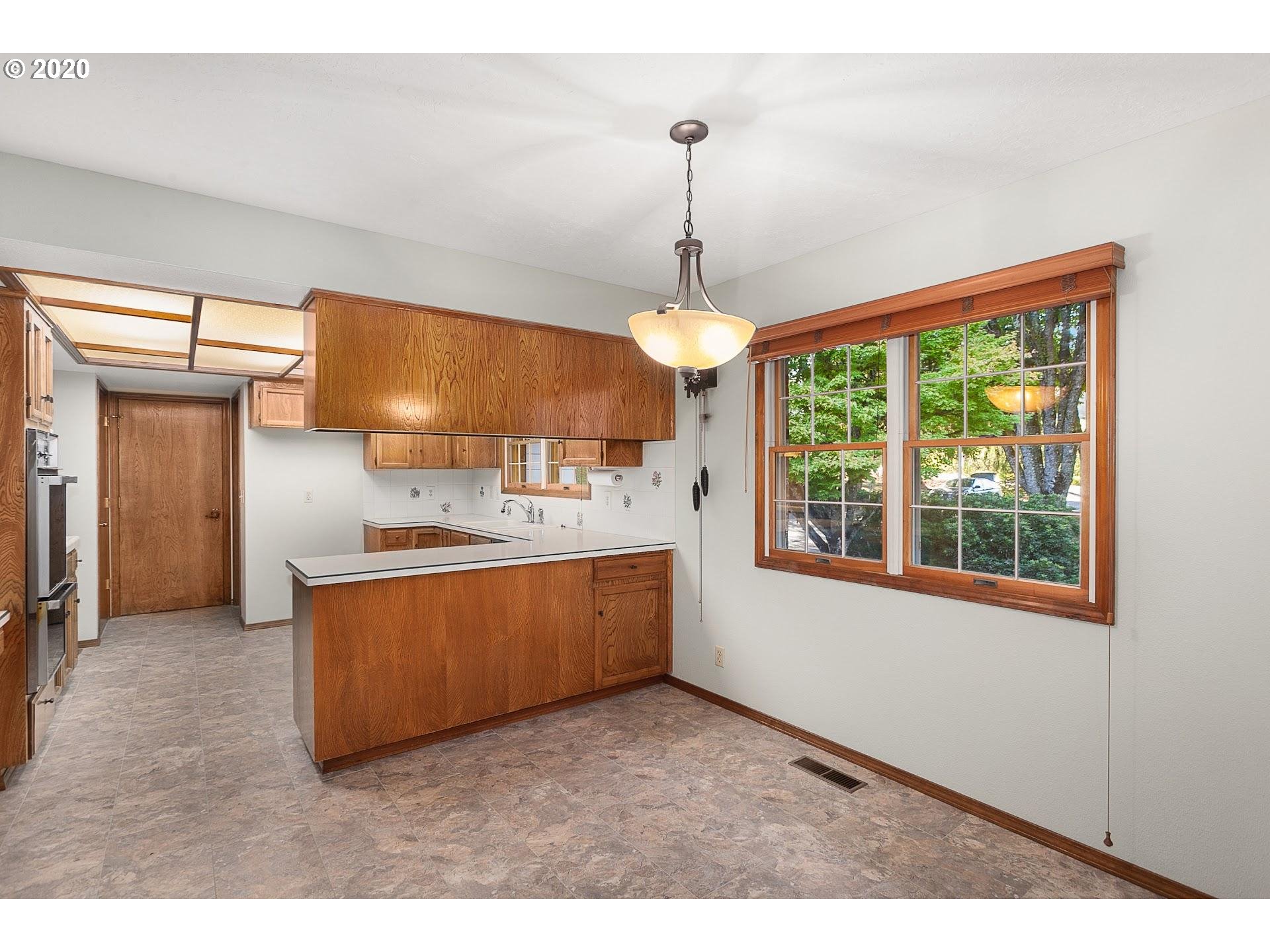 18740 Southwest Seiffert Road Sherwood, OR 97140 - Photo 7 of 32 a kitchen with stainless steel appliances granite countertop a sink a stove and a refrigerator