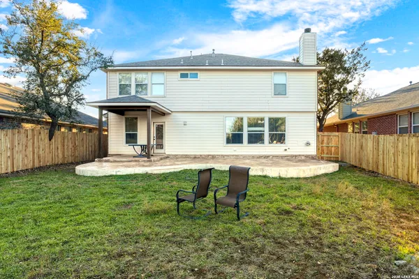 a view of a house with backyard and sitting area
