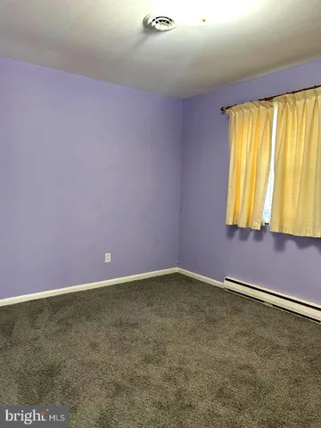 a view of a hallway with wooden shelves